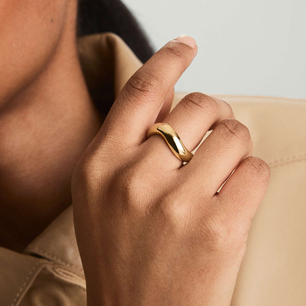 curved figure ring on hand