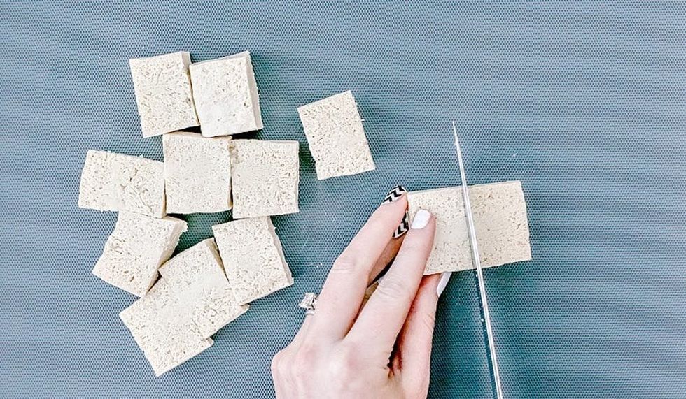 cutting blocks of frozen tofu