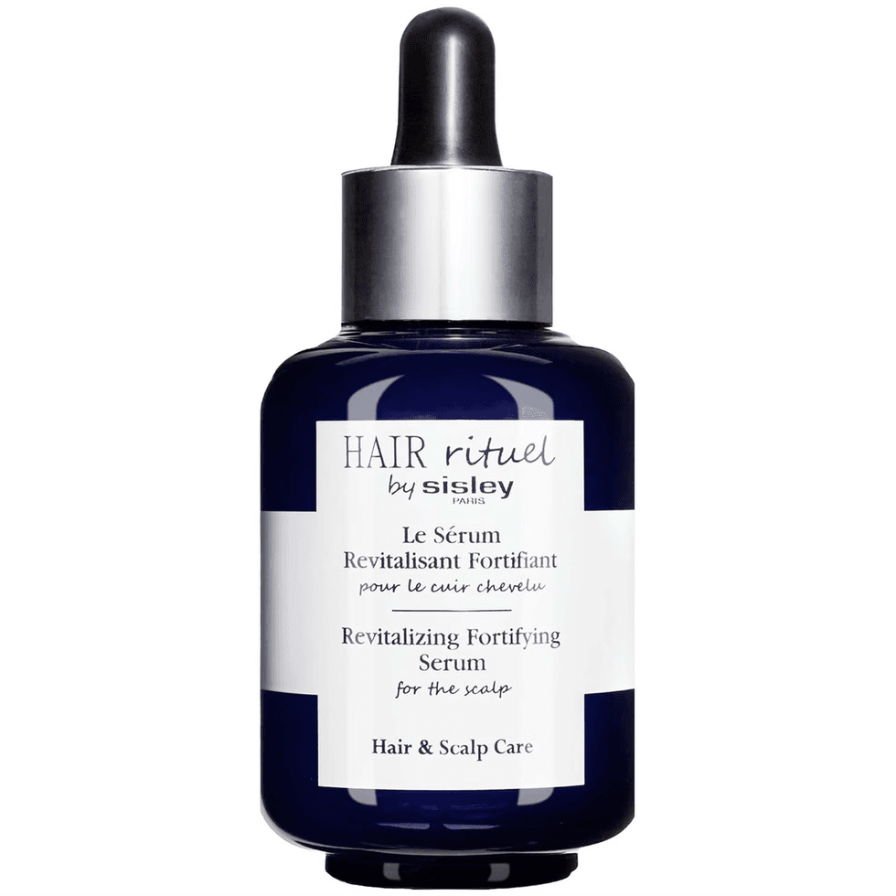 Dark blue bottle of Hair Rituel by Sisley revitalizing serum.
