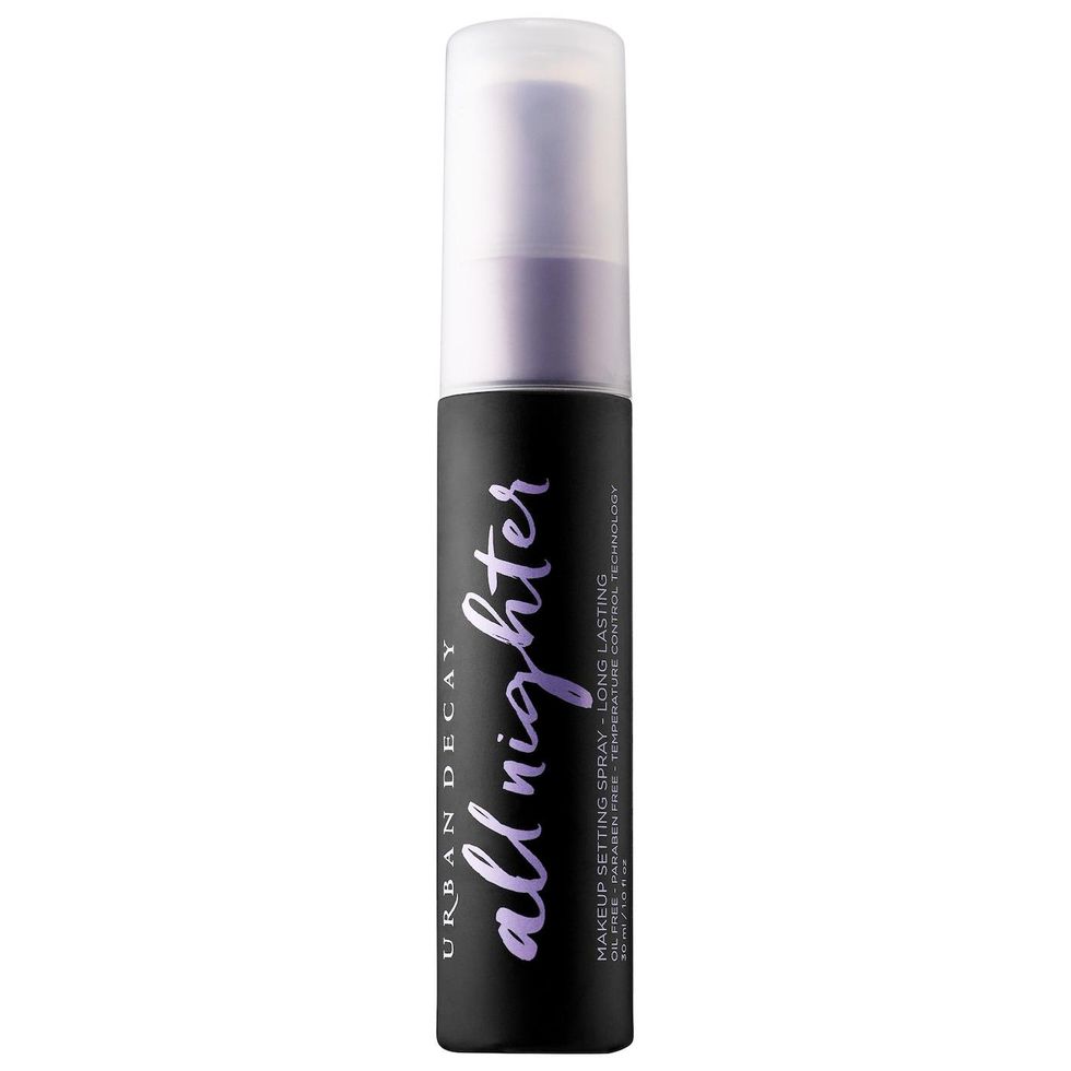 Dark bottle with a purple script font hold a long-lasting makeup setting spray from Urban Decay.