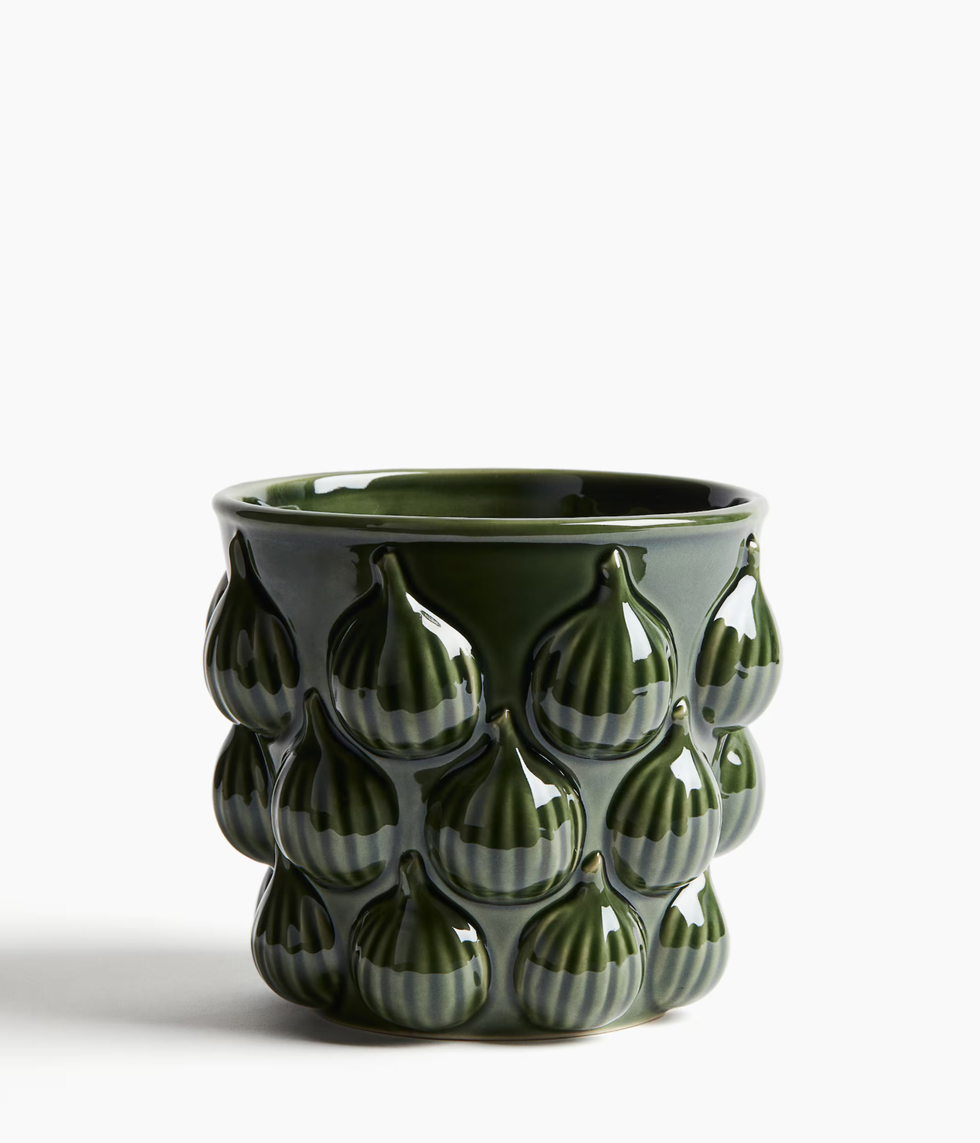 Dark green ceramic pot with fig patterns embossed on the surface.