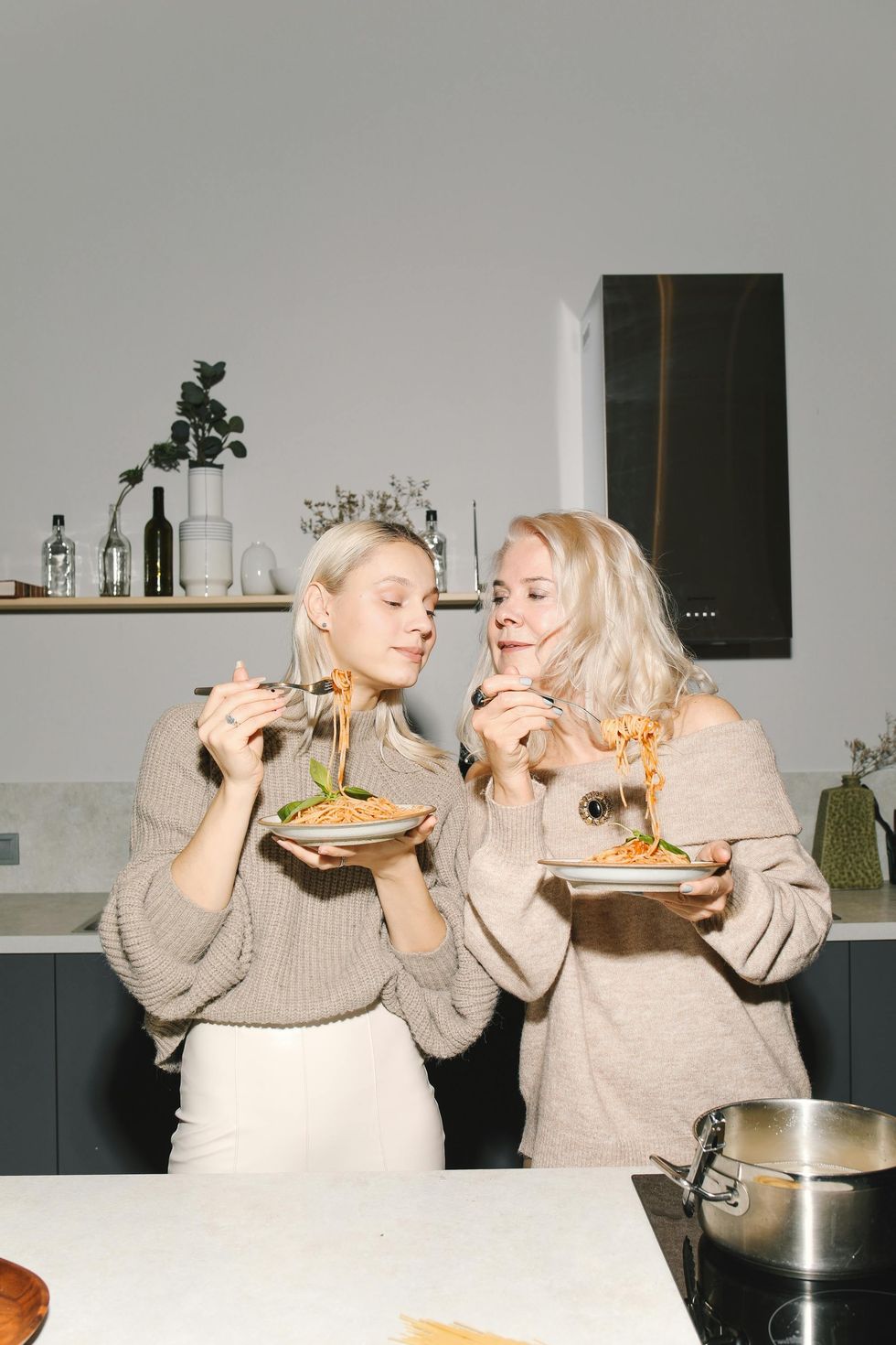 daughter and mom in kitchen eating meal together