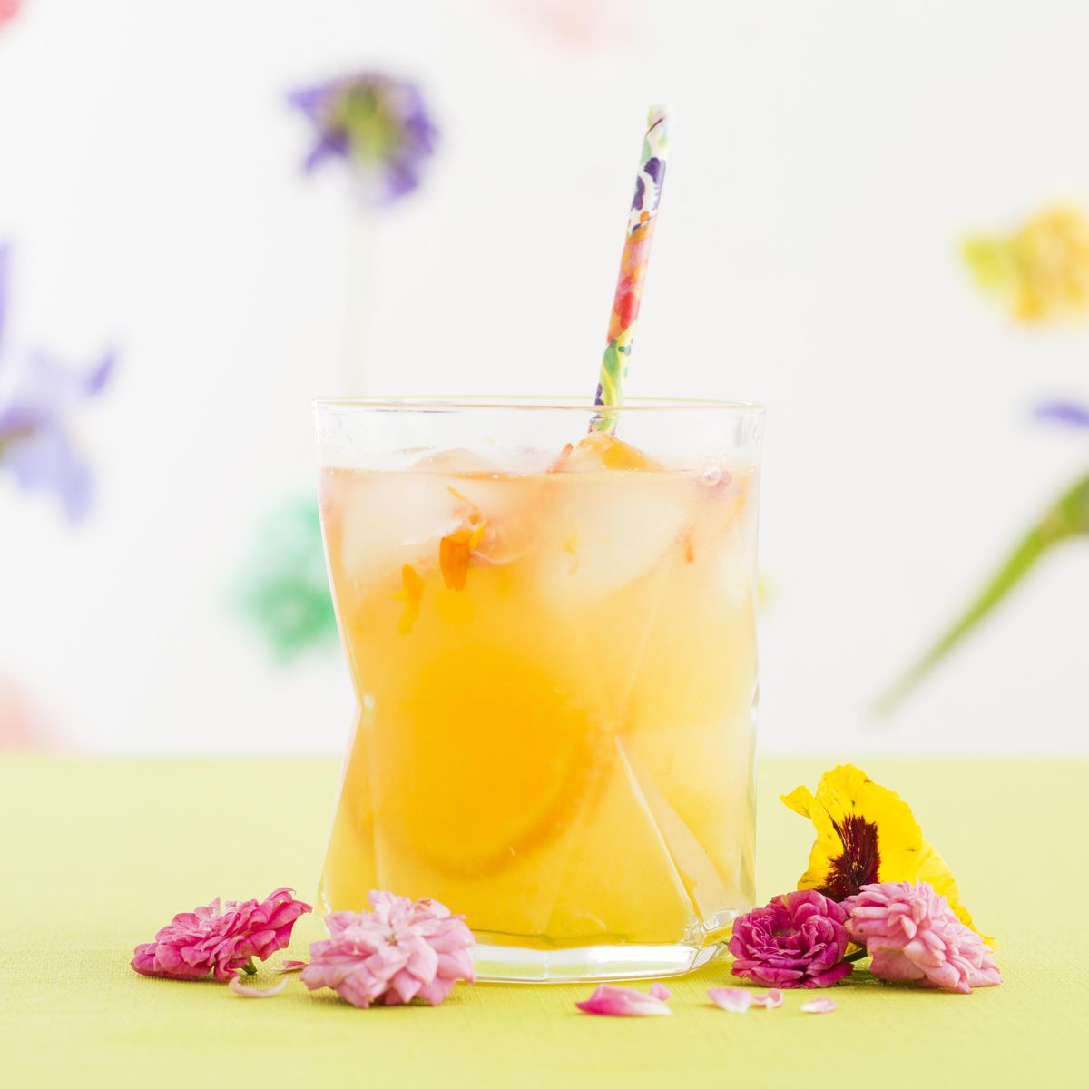 diy turmeric tonic surrounded by pink flowers