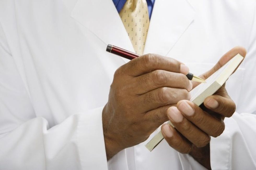 Doctor writing prescription, close-up