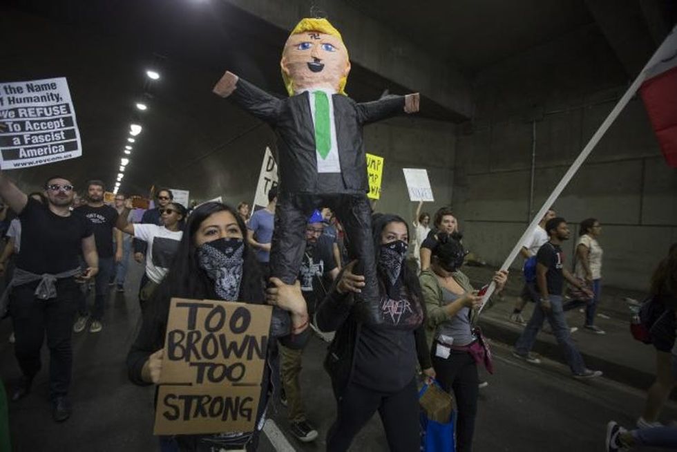  Donald Trump over Democrat Hillary Clinton in the race for President of the United States on November 12, 2016 in Los Angeles, California, United States. Hundreds of Angelenos have been arrested in recent days and some have vandalized property but the vast majority of the thousands of protesters have remain peaceful. (Photo by David McNew/Getty Images)