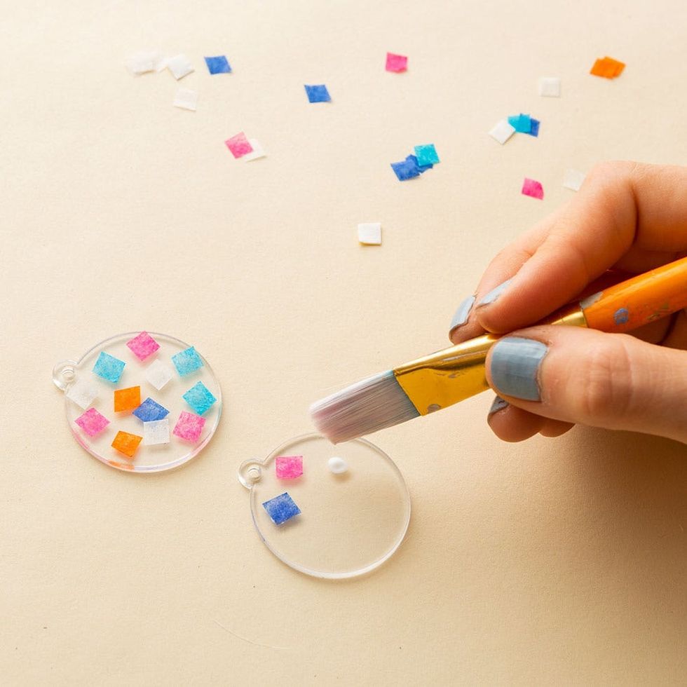 dot modpodge onto the acrylic to attach the confetti and help it stay