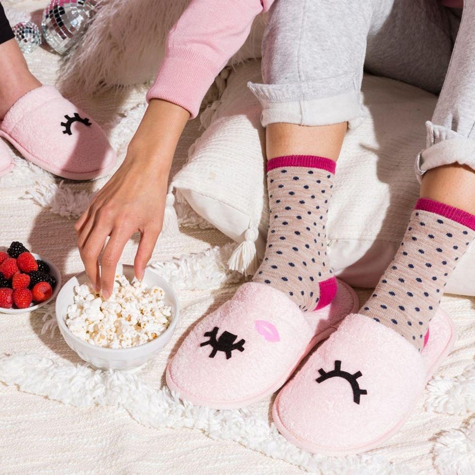 eating fruit and popcorn while sitting on some blankets