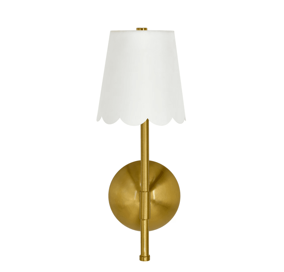 Elegant gold wall sconce with scalloped white lampshade.