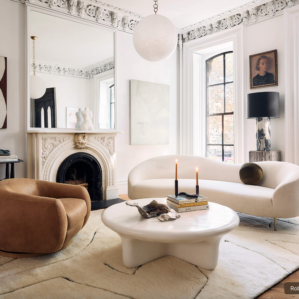 Elegant living room with fireplace, modern furniture, and large windows.