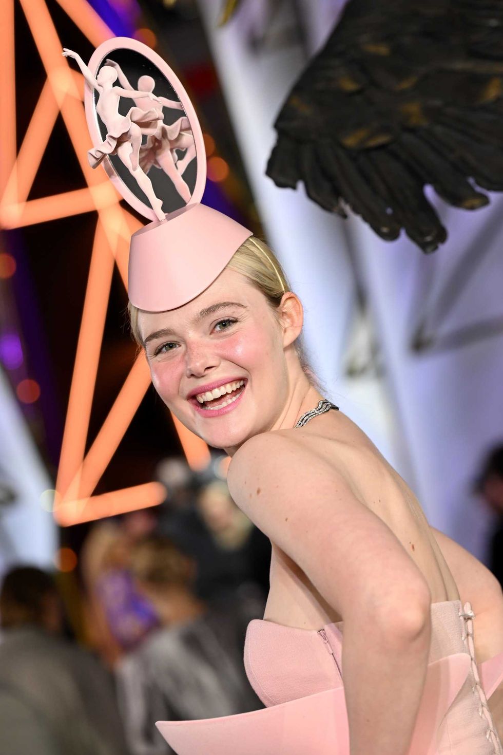 elle fanning smiling at the camera at the hunger games premiere