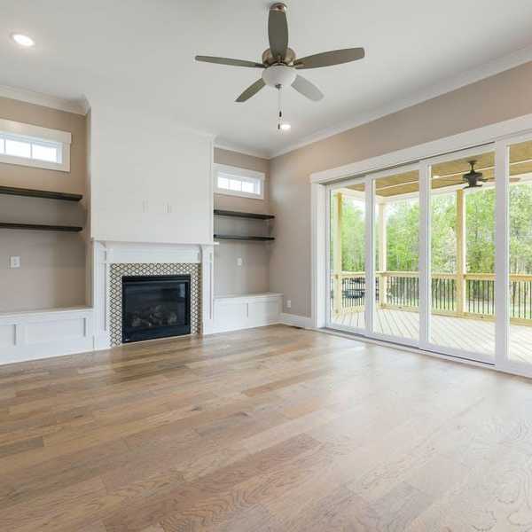 empty living room with the fan blowing
