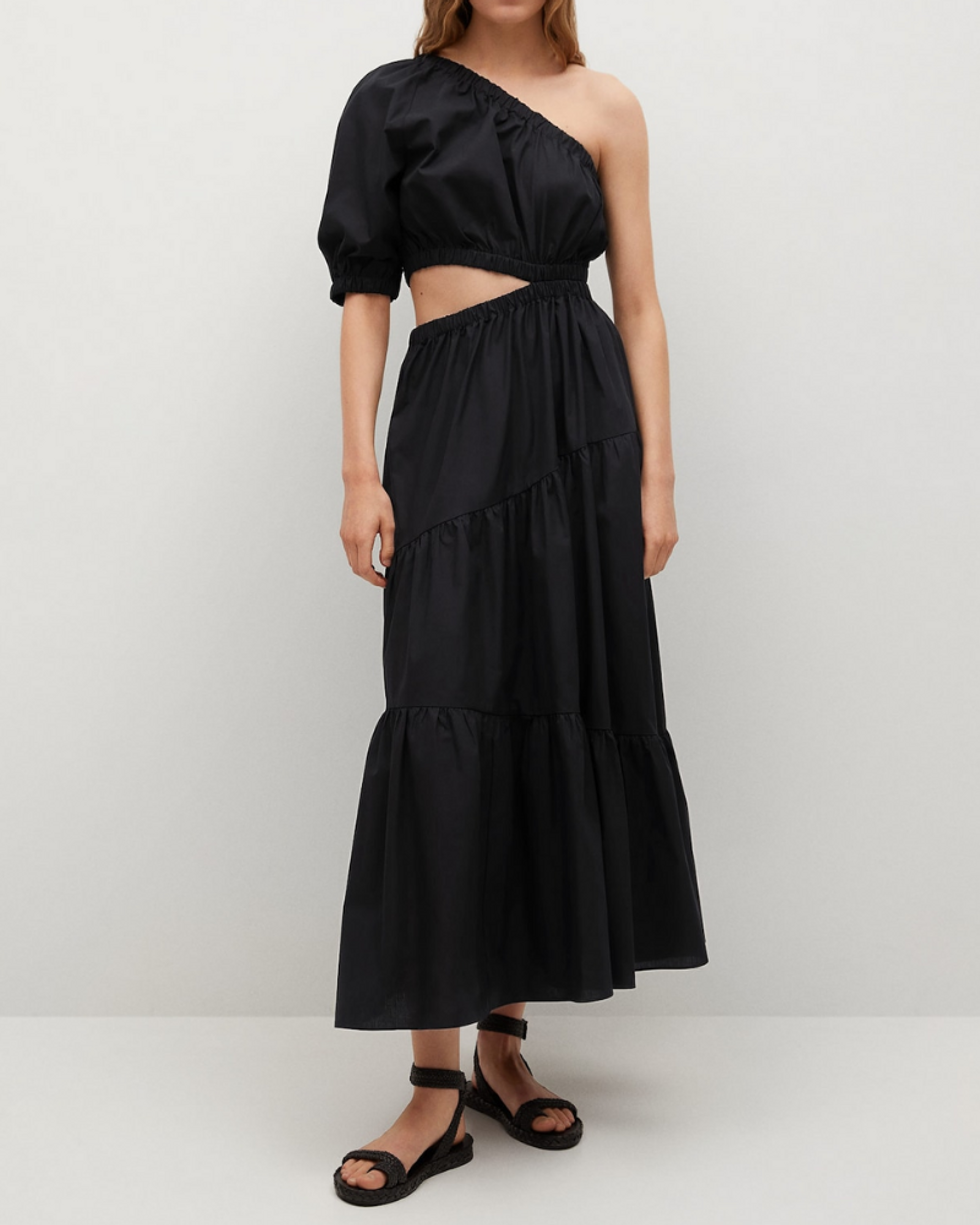 model wears black off the shoulder one sleeve dress with black sandals