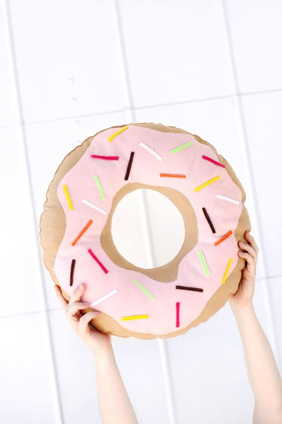 diy donut pillow with pink icing and rainbow sprinkles