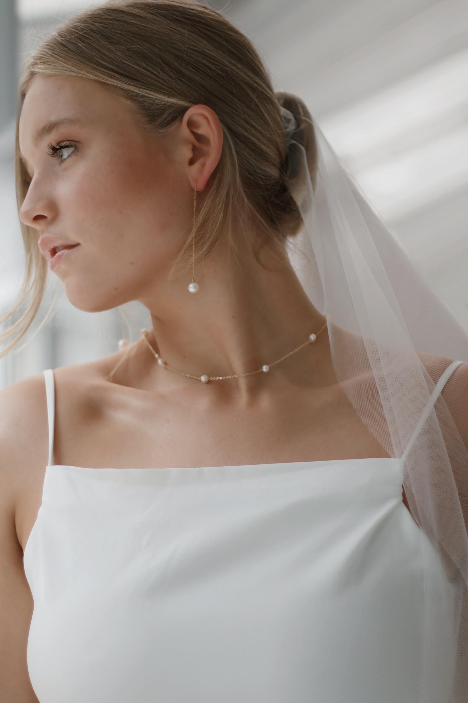 bride wearing lots of pearls 2022 Wedding Trends