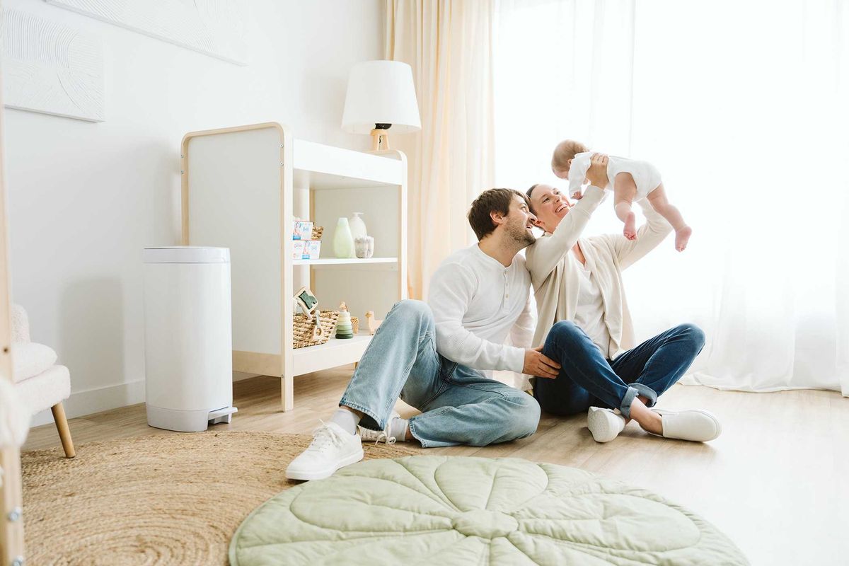 Family enjoying quality time with their baby in a bright, cozy living room.