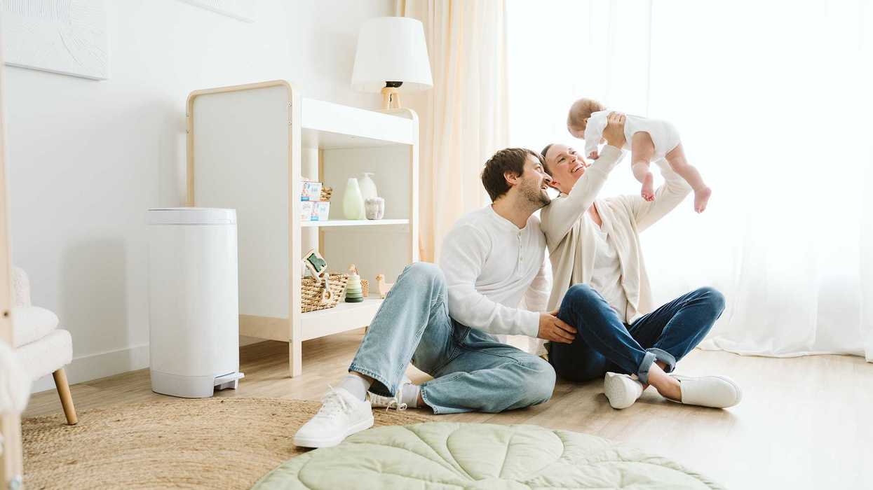 Family enjoying quality time with their baby in a bright, cozy living room.