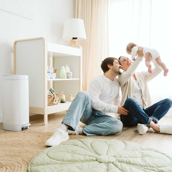 Family enjoying quality time with their baby in a bright, cozy living room.