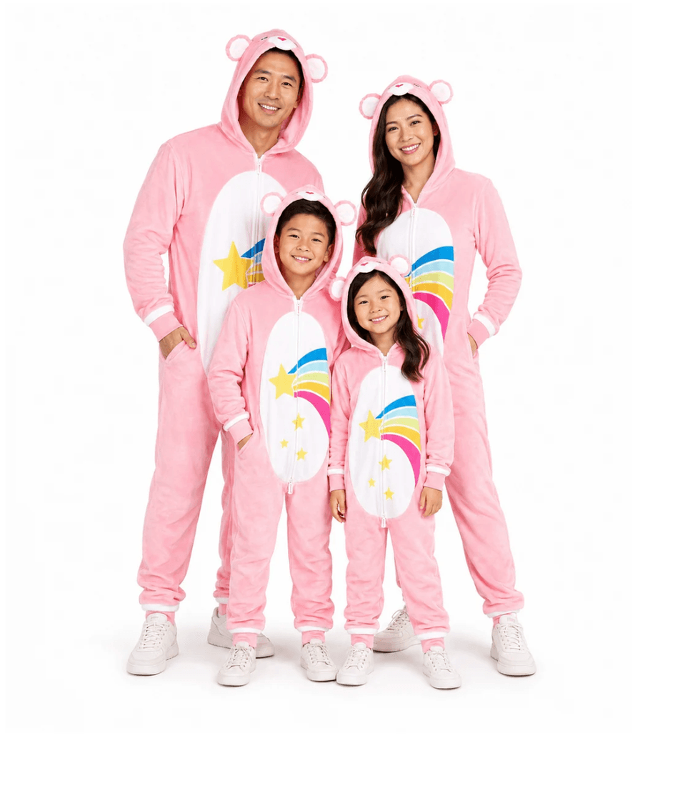 Family in matching pink bear onesies, featuring colorful rainbow and star designs.