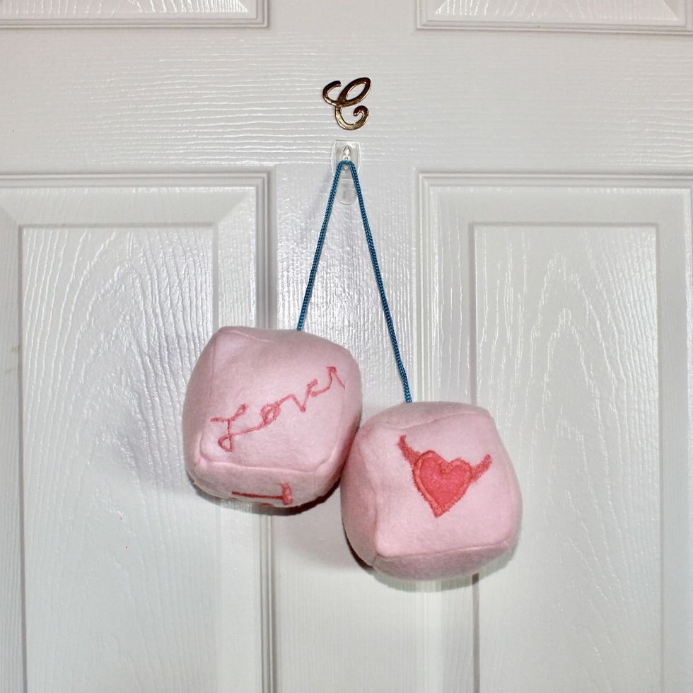 finished fuzzy dice hanging on a door Taylor Swift cruel summer