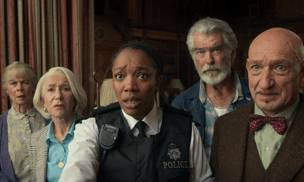 Five concerned people, including a woman in a police uniform, look towards the camera indoors.