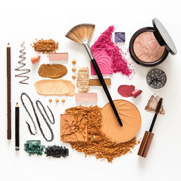 Flat layout of various colors and sizes of beauty products.