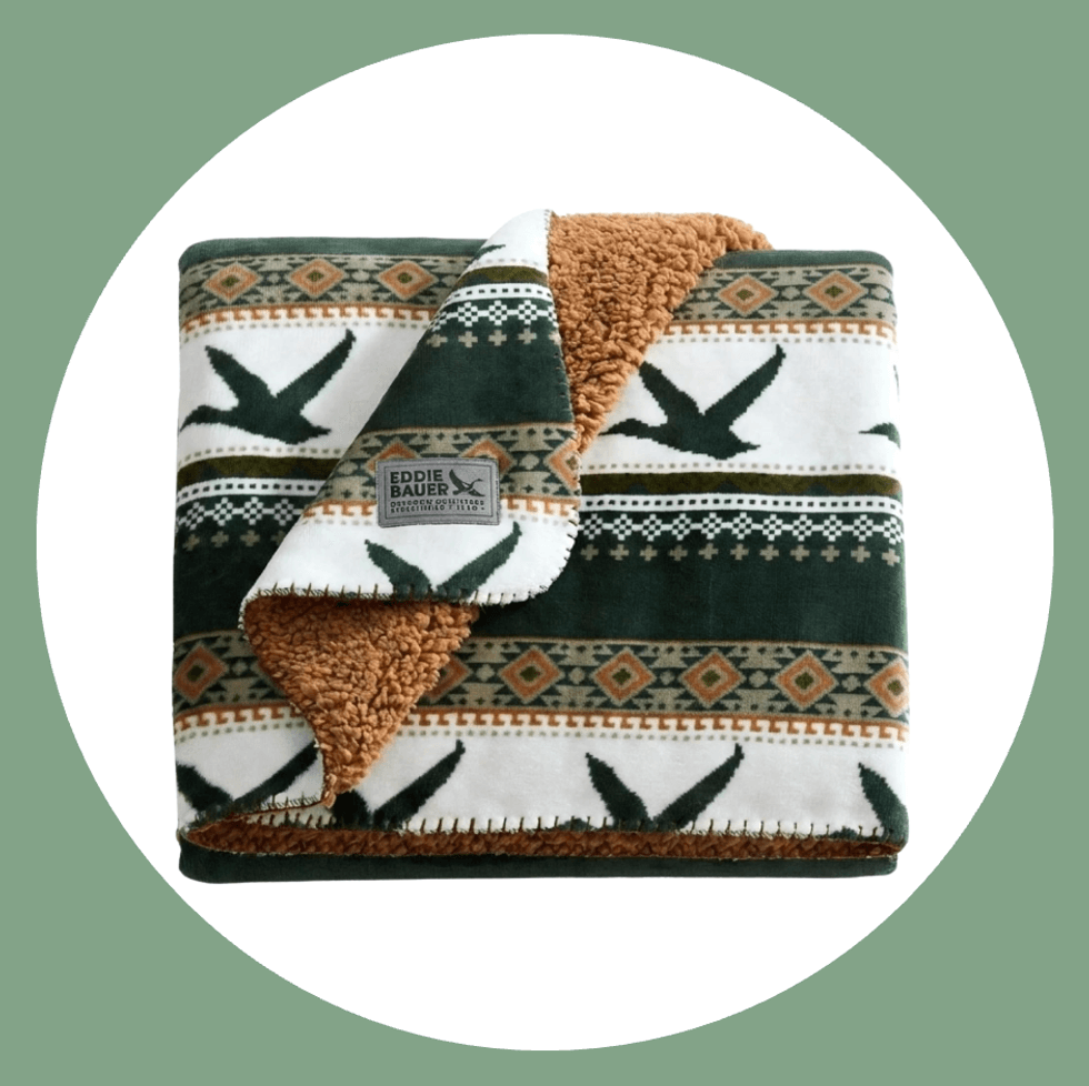 Fleece blanket with green and brown geometric patterns, Eddie Bauer label visible.
