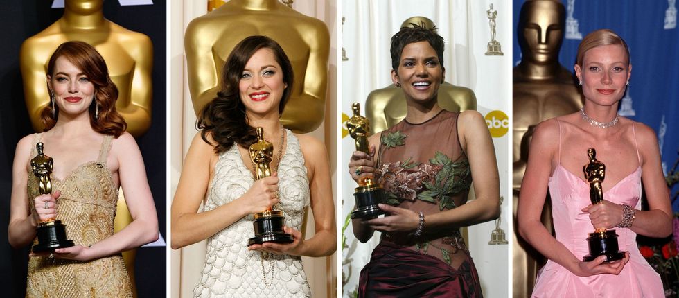 Four women holding Oscars, standing against gold statuettes backdrop.