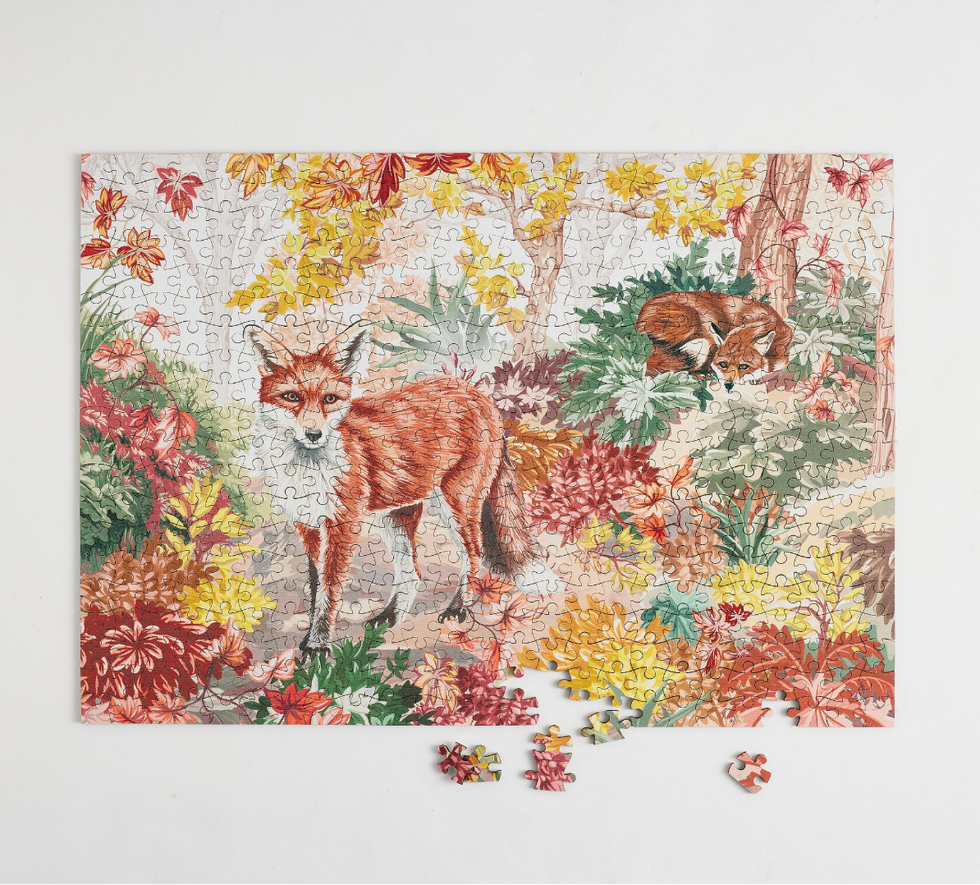 Foxes in autumn forest puzzle with a few pieces missing.