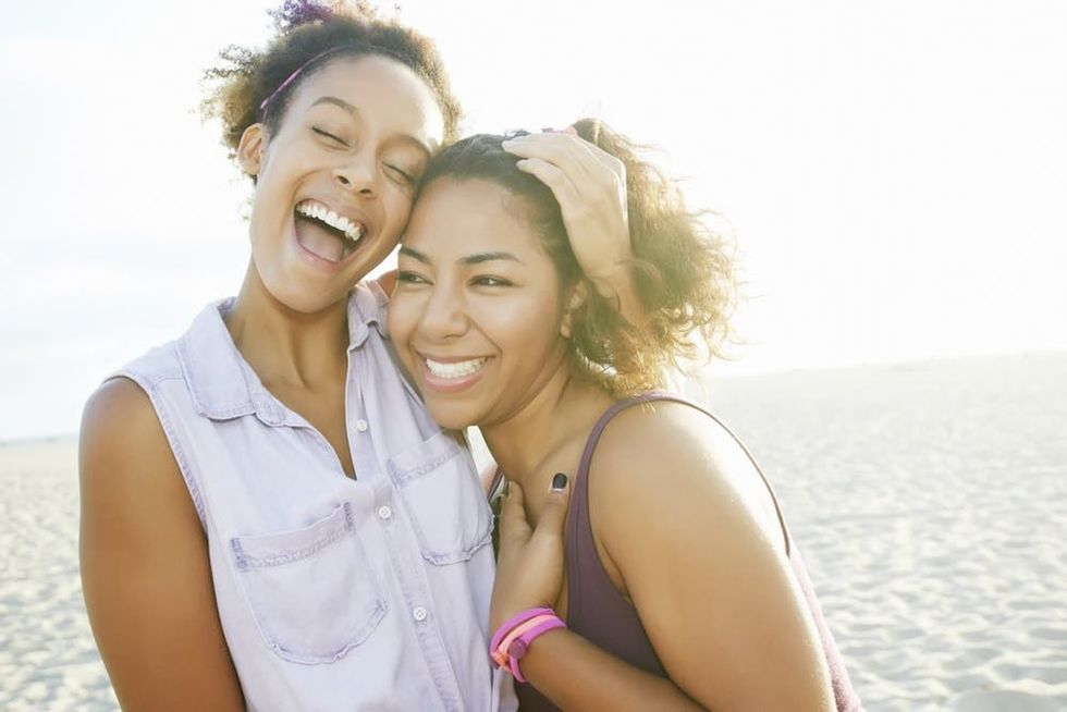Friends hugging on beach