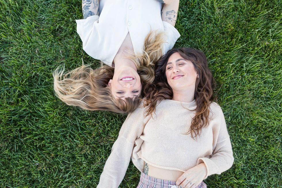 friends lying on the grass together