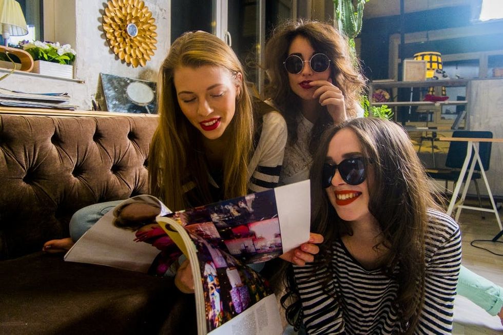 Friends page through a magazine