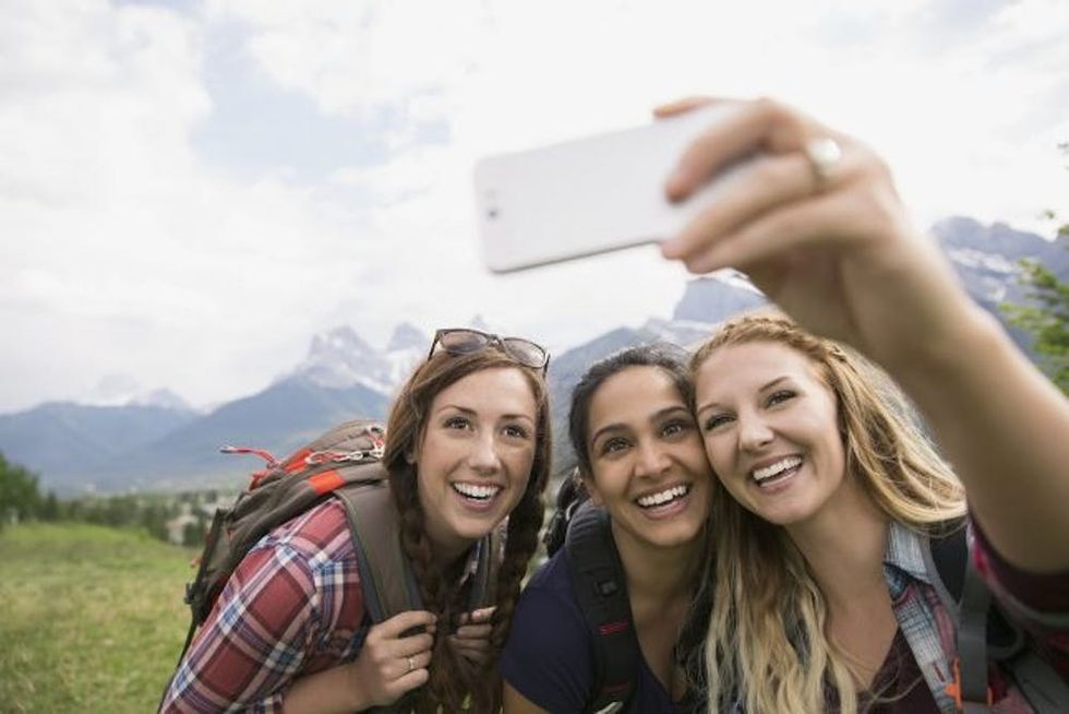 Friends taking selfie near mountains