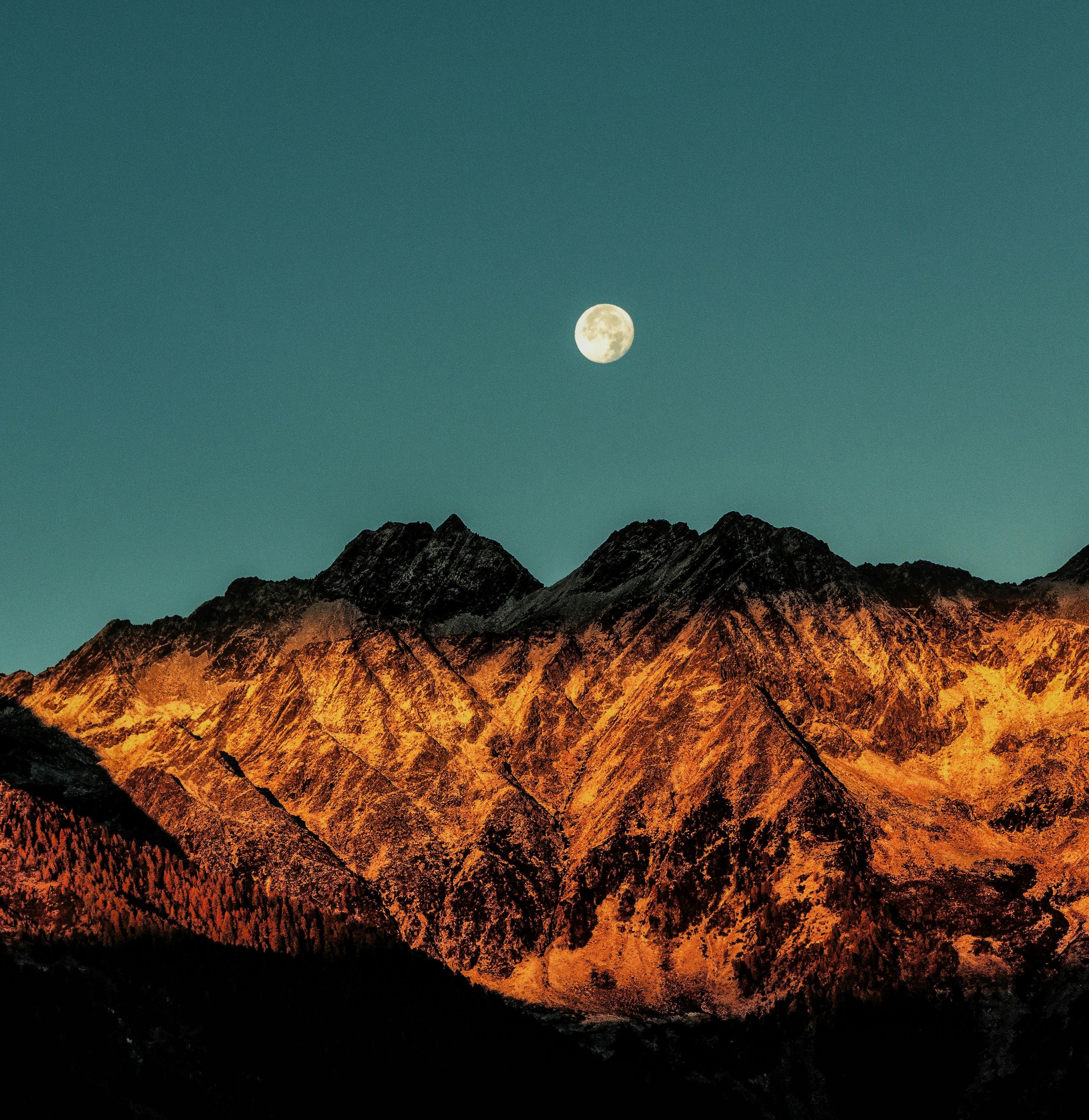 full moon over the mountains