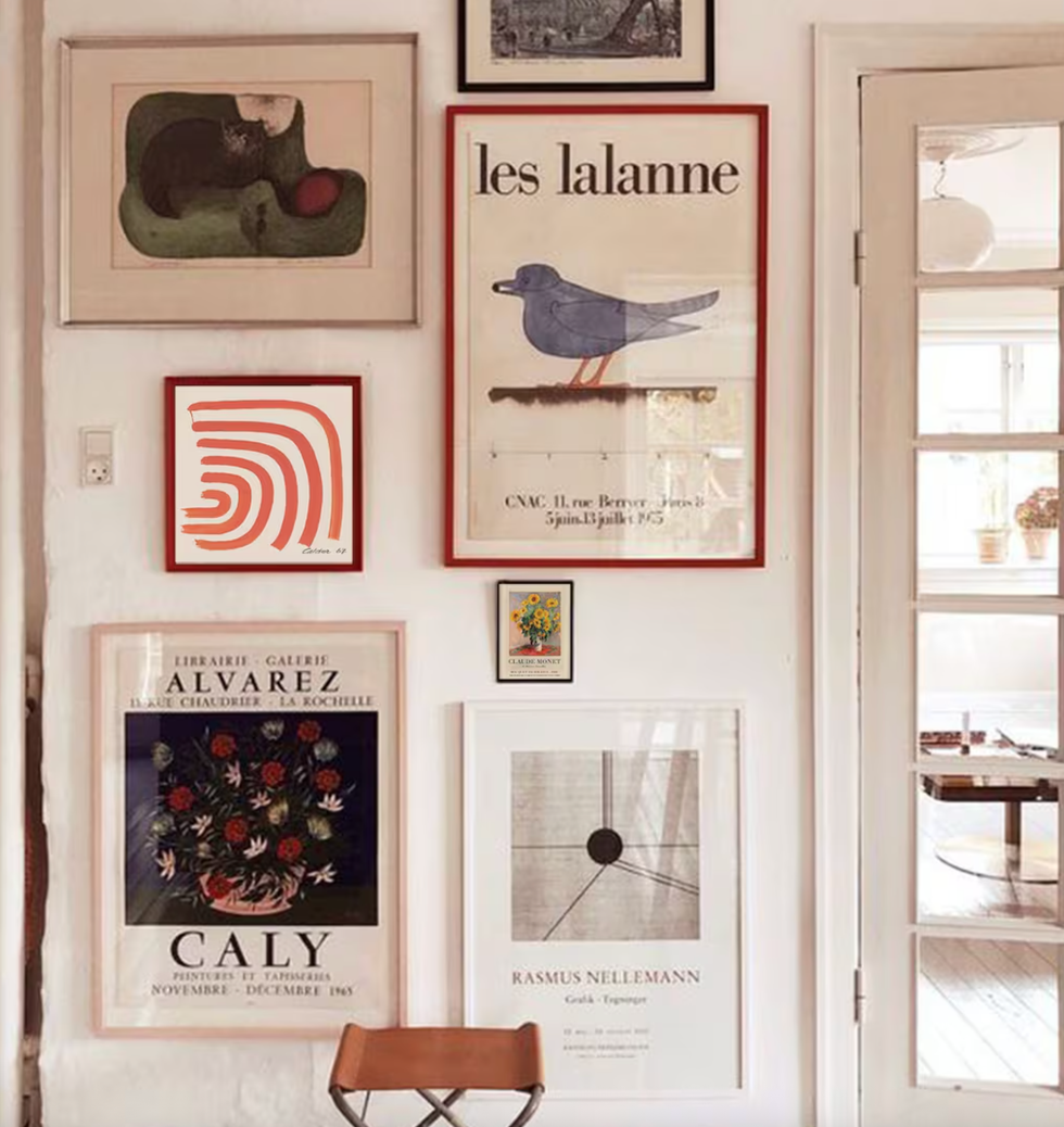 Gallery wall with framed posters and art in a cozy interior.