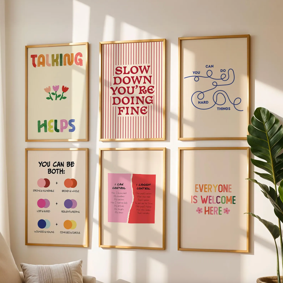 Gallery wall with six motivational art prints in gold frames.