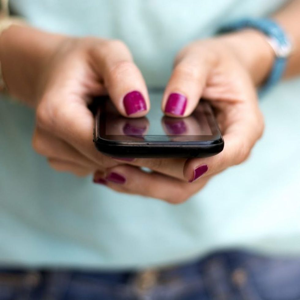 Girl holding smart phone outside