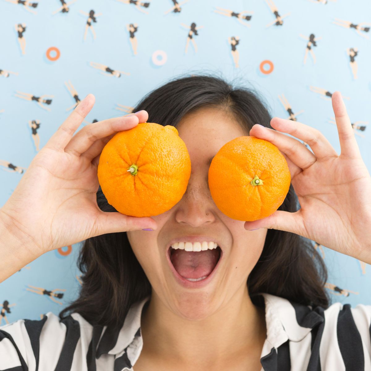 girl holding up oranges to her eyes 2022 food trends