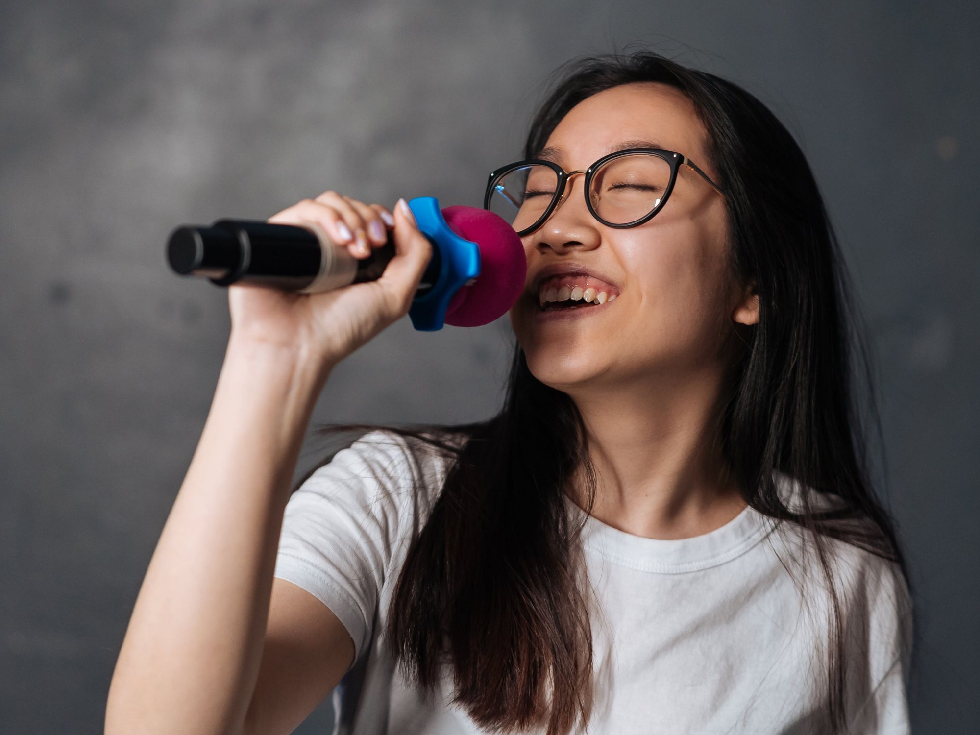 girl singing into a mic for karaoke