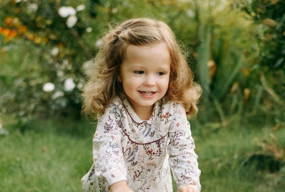girl smiling and playing in the yard