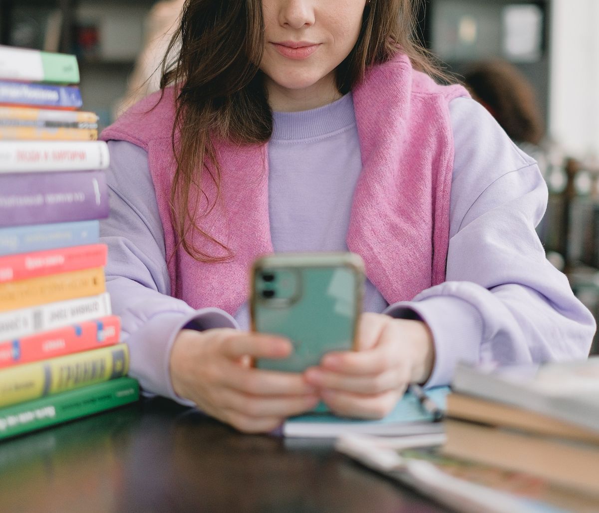 girl with books on her phone social media and mental health