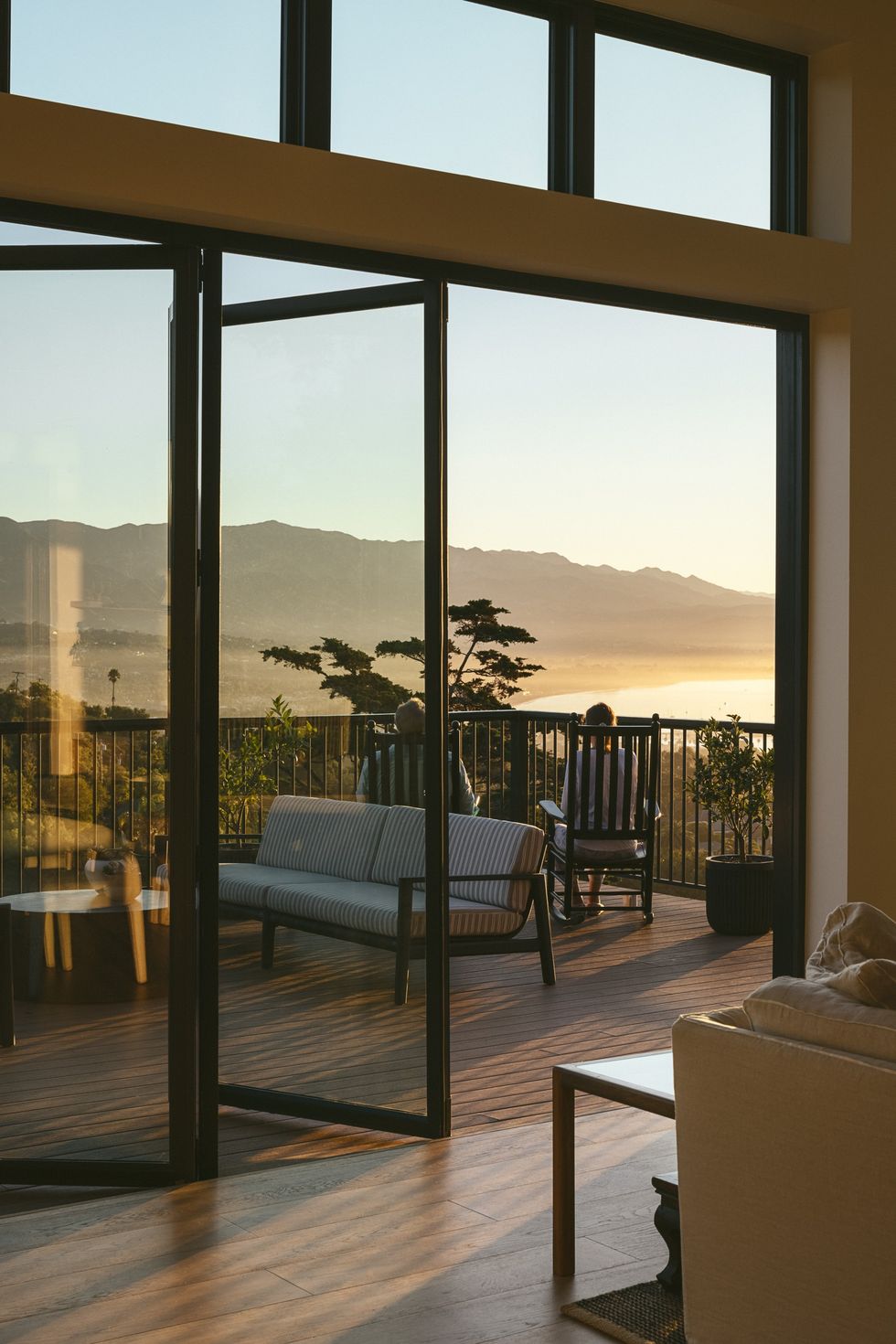 glass doors open out to a porch at sunset