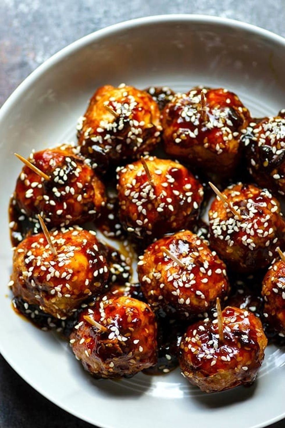 Glazed meatballs have toothpicks in them.