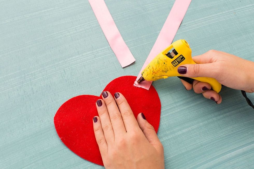 gluing the ribbon to the felt heart
