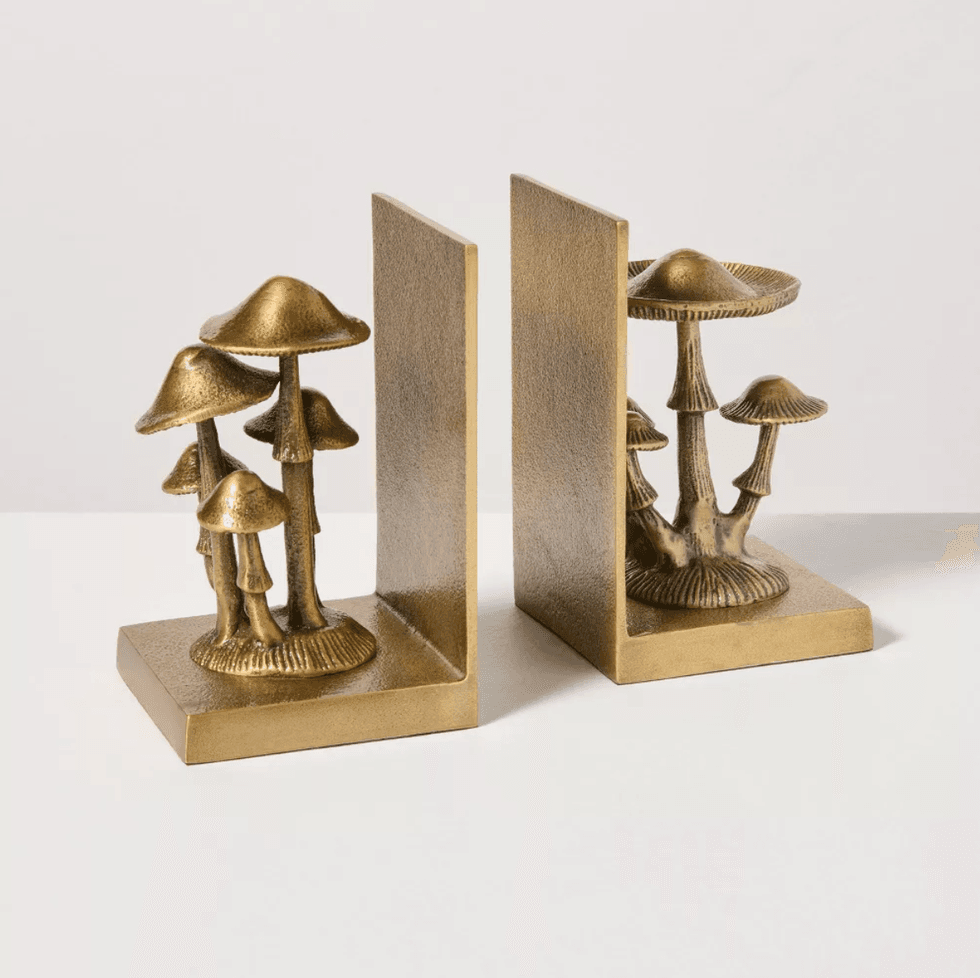Gold bookends featuring mushroom designs.