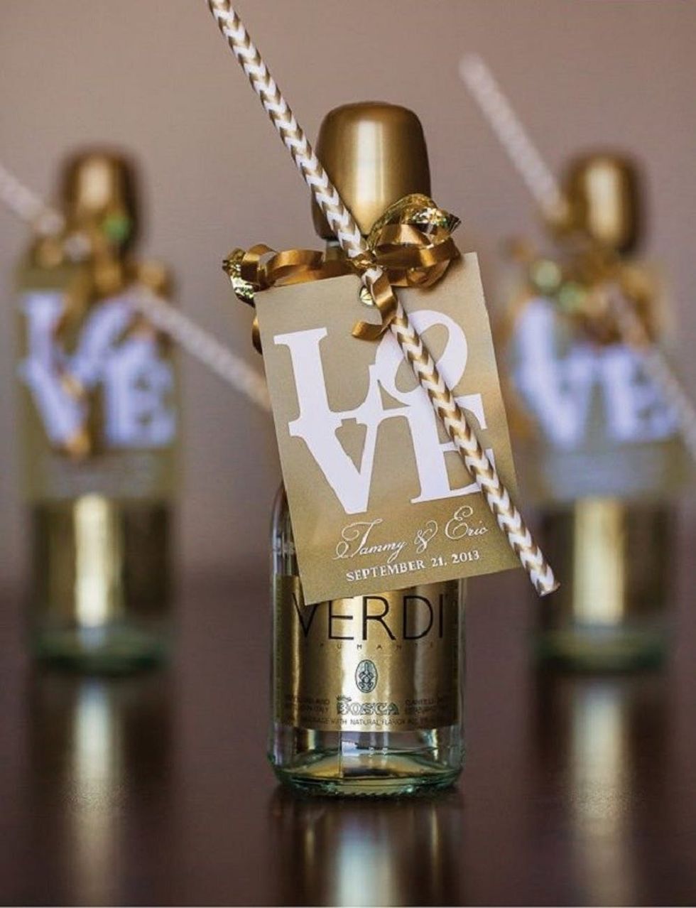 Gold champagne bottle and straw