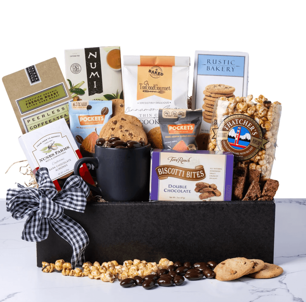 Gourmet gift basket with cookies, popcorn, coffee, and chocolate treats.