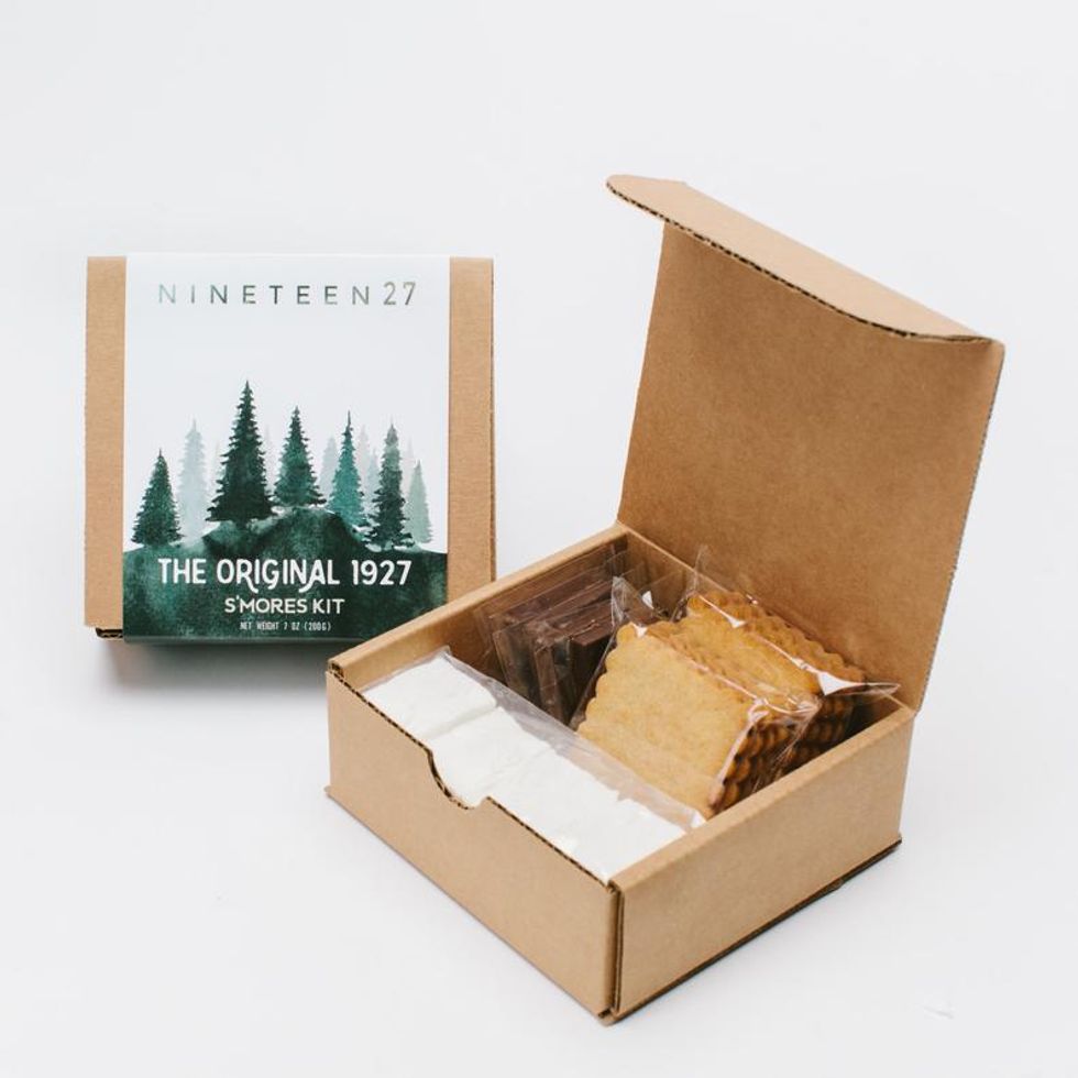 gourmet s'mores with marshmallow, graham crackers and chocolate and a forest image on the box
