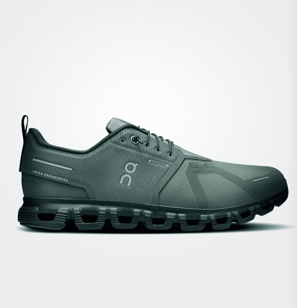 Green athletic shoe with unique sole design, featuring Swiss engineering branding.