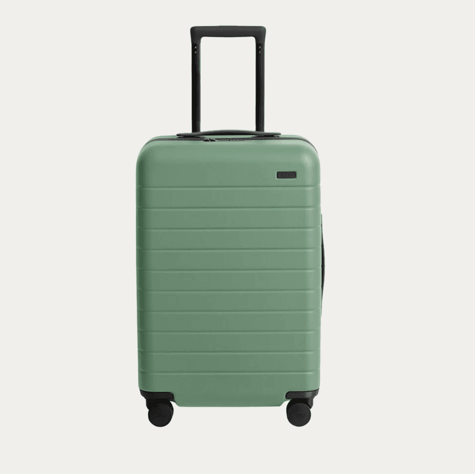 Green hardshell suitcase with telescopic handle and four wheels.