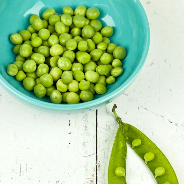 green peas in a bowl and pea pod vegan protein sources
